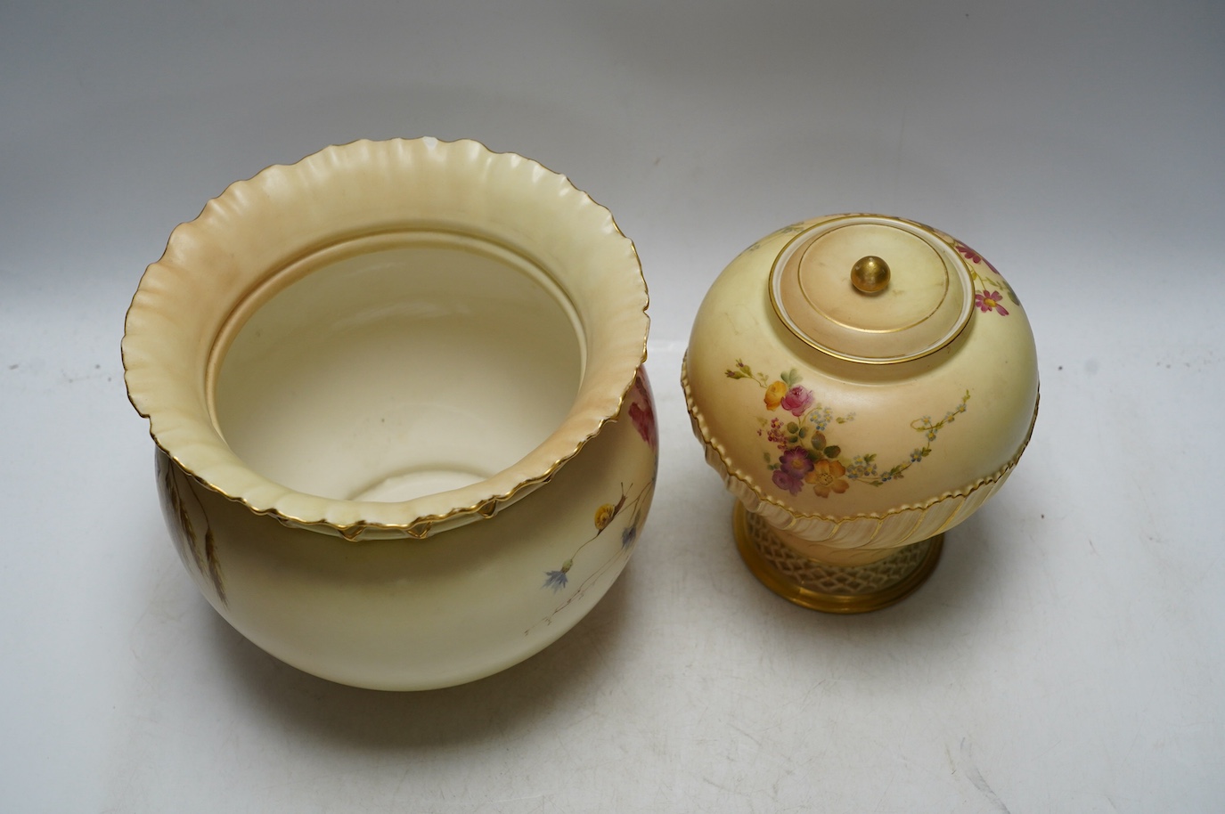 A Worcester blush ivory floral jardiniere, 1651, and a jar and cover, 1720, largest 17cm high. Condition - good, jardiniere with a chip to top rim